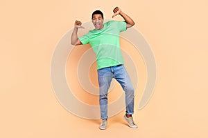 Full size photo of cool handsome optimistic guy dressed green t-shirt denim pants directing at himself isolated on beige