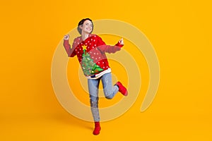 Full size photo of crazy funky girl dance x-mas newyear party wear christmas tree decor jumper jeans boots isolated over