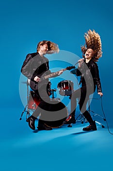 Full size photo crazy funky two people youth rock band woman sing song mic man play bass guitar enjoy night club garage