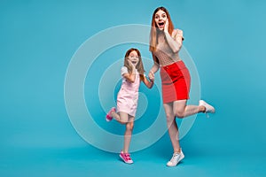 Full size photo of foxy little lady and her mom listen unexpected sale news wear casual clothes isolated blue background