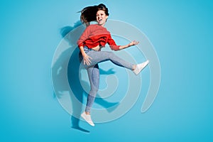 Full size photo of funky crazy lady jump flight play imaginary guitar musician  blue color background