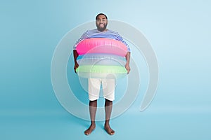 Full size photo of funky funny barefoot afro american guy enjoy weekend have colorful ring float lifesaver buoy ready