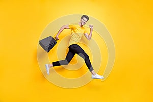 Full size photo of handsome guy jumping high holding many packages speed rushing sale shopping wear casual t-shirt black