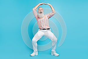 Full size photo of handsome senior man happy positive smile have fun dance music isolated over blue color background