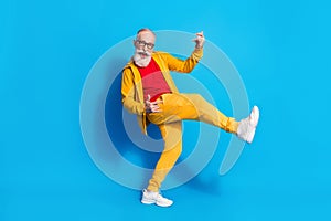 Full size photo of happy good mood excited funky grandfather playing invisible guitar isolated on blue color background