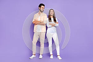 Full size photo of happy man and woman couple look each other folded arms good mood harmony isolated on purple color