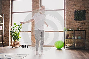 Full size photo of happy positive smiling grandfather jumping with jumping rope doing cardio at home house