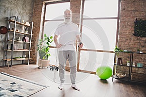 Full size photo of happy smiling active energetic mature man grandfather exercising doing cardio at home house