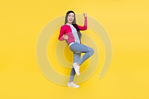 Full size photo of hooray brunette young lady hands fists wear pink sweater jeans  on yellow background
