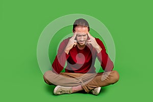 Full size photo minded pensive guy wear red shirt brown trousers sit on floor think solution of problem isolated on