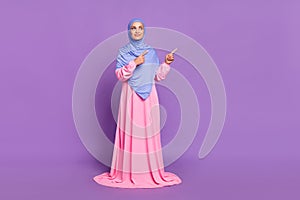 Full size photo of nice young lady indicate look advice ramadan holiday wearing muslim pink dress isolated over purple