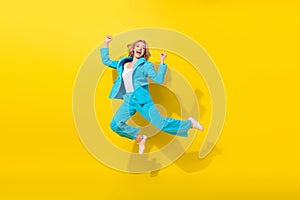 Full size photo of overjoyed good mood girl dressed blue jacket trousers jumping raising fists win gambling isolated on