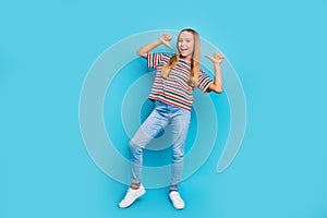 Full size photo of perky optimistic teen girl wear colorful t-shirt denim pants directing at herself isolated on blue