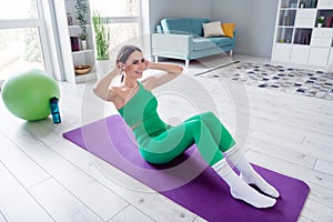 Full size photo of positive determined slender girl doing abs workout fitness carper modern flat indoors