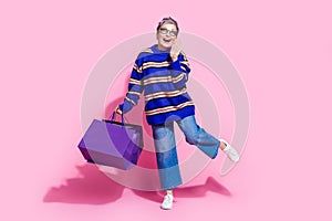 Full size photo of pretty retired female excited shopping announce dressed stylish blue striped outfit isolated on pink
