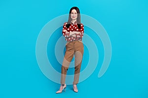 Full size photo of satisfied successful person wear red blouse brown trousers standing palms folded isolated on blue