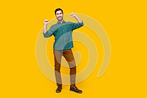 Full size photo of self confident man dressed dotted shirt brown trousers directing at himself isolated on yellow color