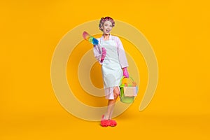 Full size photo of surprised girl maid hold fluffy duster bucket wear bath robe gloves isolated shine color background