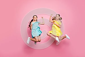 Full size photo of two friendship small sisters ladies jumping high celebrate summer holidays last school day wear blue