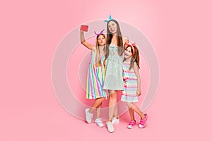 Full size photo of woman and two schoolkids with long blonde brunette haircut send air kisses making selfie wear skirt