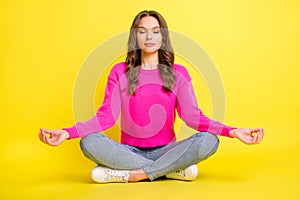 Full size photo of young attractive beautiful relaxed peaceful girl sitting floor doing yoga isolated on yellow color