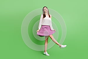 Full size photo of young beautiful cheerful smiling positive girl go walk wear pretty violet skirt  on green