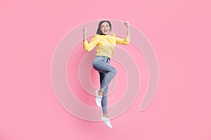 Full size photo of young beautiful excited smiling happy girl jump in victory raise hands  on pink color