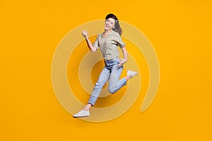 Full size photo of young beautiful funky happy smiling girl jump play invisible guitar isolated on yellow color