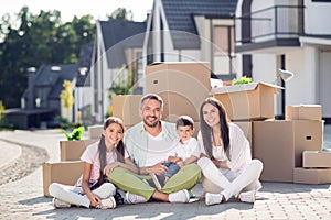 Full size photo of young cheerful family daddy mommy child childhood sit together harmony cozy comfort happy enjoy move