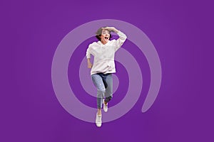 Full size photo of young exicted smiling female running fast traveling sightseeing isolated on violet color background
