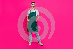 Full size photo of young guy shopkeeper assistant hairstylist isolated over magenta color background