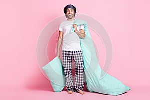 Full size photo of young happy excited crazy man hold blanket and pillow good morning isolated on pink color background