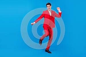 Full size photo of young man happy positive smile have fun dance party  over blue color background