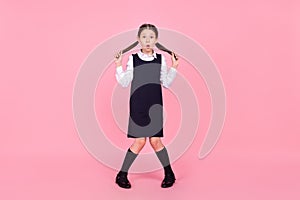 Full size photo of young school girl amazed shocked surprised shy isolated over pink color background