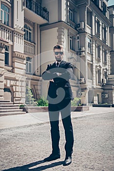 Full size portrait of a harsh agent outdoors. He looks stunning