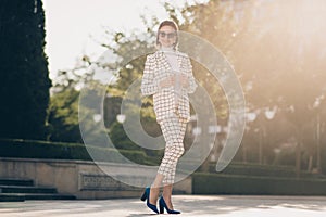 Full size portrait of luxury gorgeous lady posing arms adjust blazer warm sunny weather outside