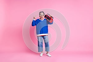 Full size portrait of nice aged lady boombox show heavy metal symbol wear blue sweater isolated on pink color background