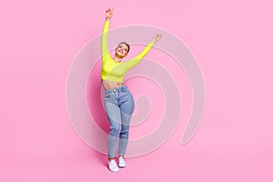 Full size portrait of nice lovely girl closed eyes raise hands dancing empty space isolated on pink color background