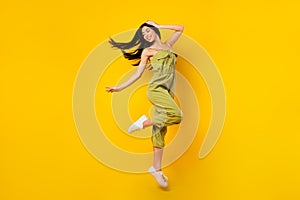 Full size portrait of nice peaceful person jumping hand touch head isolated on yellow color background