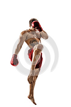 Full size of professional kickboxer in red sportswear on white background. muscular athlete fighting