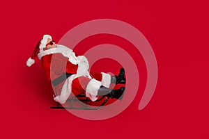 Full size profile photo of funny santa go by sled wear cap glasses coat pants shoes isolated on red color background