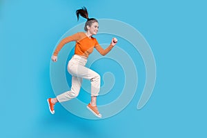 Full size profile side image of cute girl running fast speed go on adventure isolated on blue color background