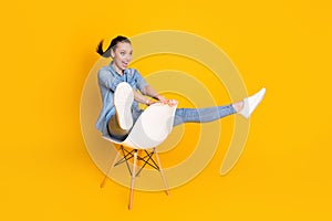 Full size profile side photo of energetic crazy girl sit chair imagine she ride mountain rider fast speed wear good look