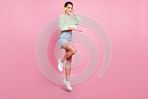 Full size profile side photo of young girl happy positive smile music dj earphones jump isolated over pastel color
