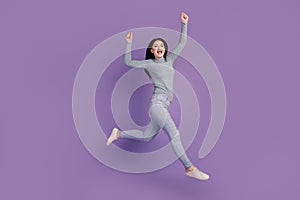 Full size profile side photo of young girl rejoice victory jump up success  over purple color background