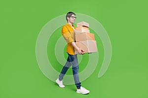 Full size profile side photo of young handsome positive man go walk moving new home isolated on green color background
