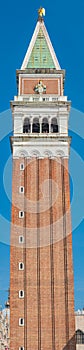 Full size view of Campanile Bell Tower at San Marco square in Venice, Italy, at sunny day and deep blue sky
