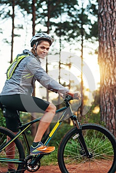 Full speed ahead. Portrait of a female mountain biker out for an early morning ride.