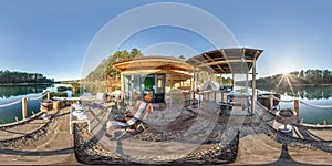 Full spherical hdri panorama 360 degrees angle view on wooden pier near house on water on lake in forest in evening in