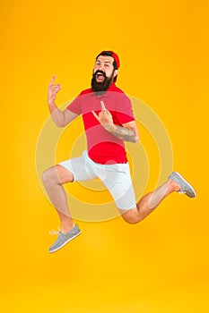 Full of strength and energy. Hipster dancing jumping. Feeling free. Running man yellow background. feel himself